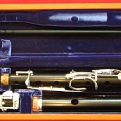 African Blackwood Flute with 9 keys, all Silver plated in it's leather clad flute case, the head-plug is made from Tulipwood and has a Mother of Pearl inlay
