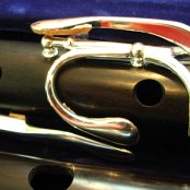 Close up the the middle section of the flute in it's case with the head in the front, with Long F-Natural, G-Sharp, B-Flat lever and C-Natural